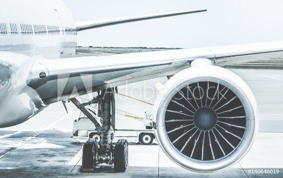 Picture of Detail of airplane engine wing at terminal gate before takeoff - Wanderlust travel concept around the world with air plane at international airport - Retro contrast filter with light blue color tones